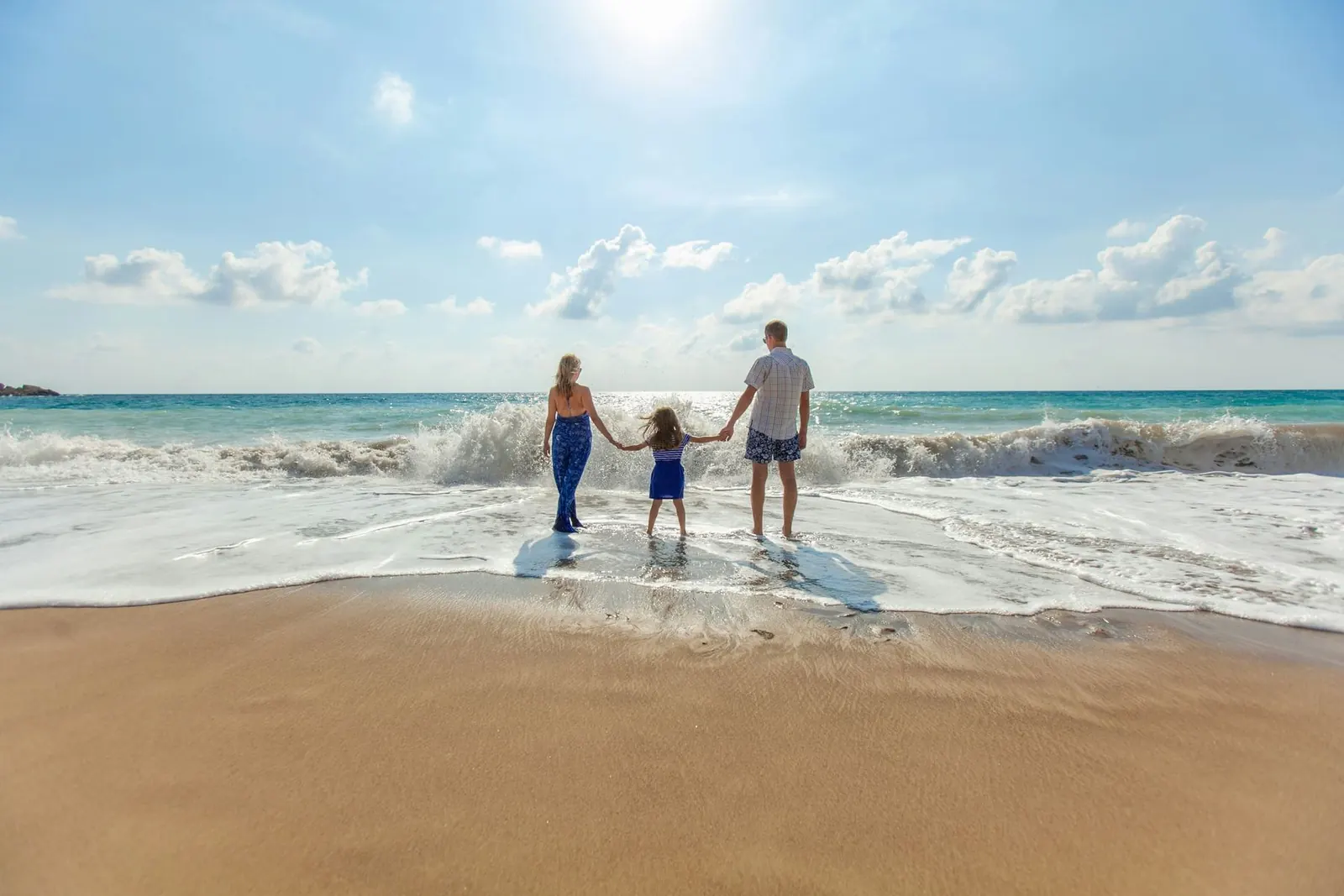 Family holding hands on the beach